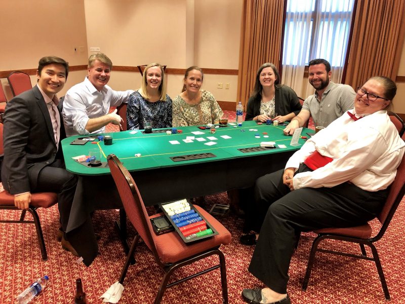 Accounting Research Conference attendees enjoying a charity poker tournament after a day of discussing leading reasearch in accounting.