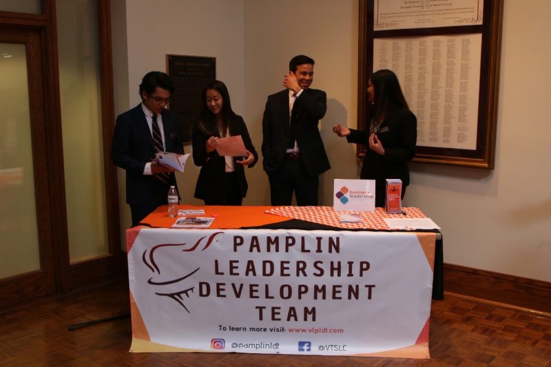 Joshua Del Rosario (far left) tends to the PLDT table with Vicky Choi, Mark Llorens, and Sharita Shamim (left to right), during the 21st Annual Leadership Development Conference.